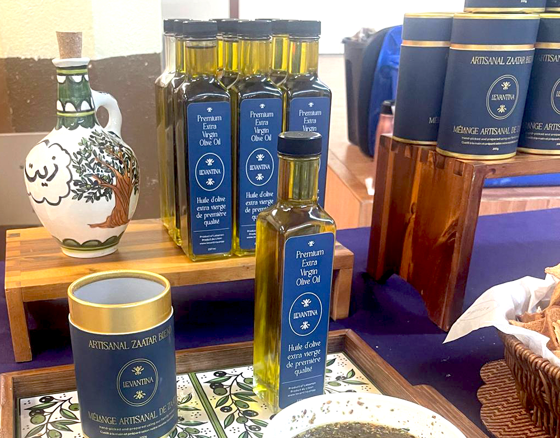 Levantina premium olive oil bottles and artisanal zaatar tins arranged on a display table
